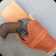 Tooled leather holster for a Modded Nerfgun.  Dyed leather with basket weave and barb wire details.