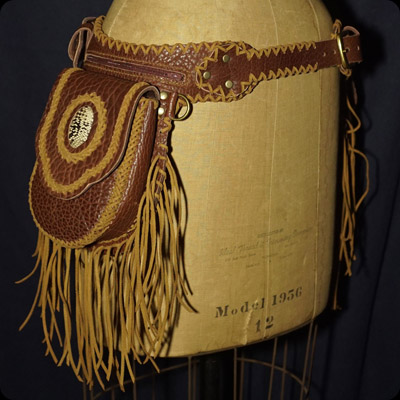 Reproduction of a pair of hip saddle bags with buffalo hide, snake skin and fringe.