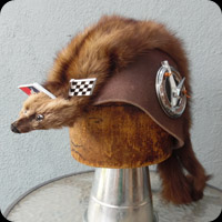 Screen accurate copy of a hat worn by Toadie in the Movie "Mad Max".  Features a weasel pelt, vehicle badges and wool base.